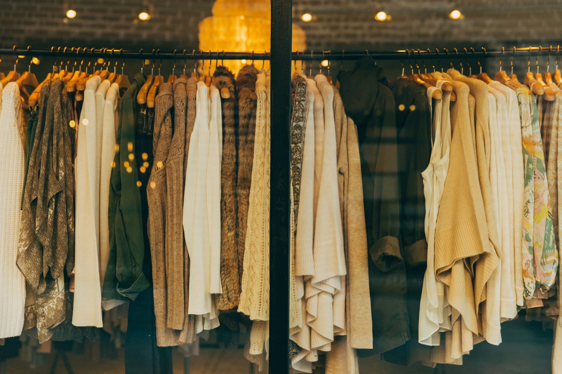Warm beige coats on a boutique clothing rack
